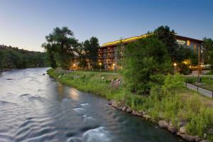 a river in front of a building next to a building at DoubleTree by Hilton Durango in Durango