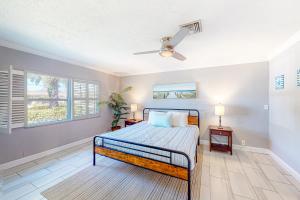 a bedroom with a bed and a ceiling fan at Ariana's Paradise in St Pete Beach +27 photos
