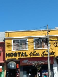 un bâtiment jaune avec un panneau d'hôtel dans l'établissement Hostal Valle Central San Fernando, Chile, à San Fernando
