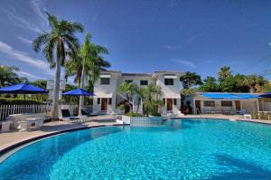 a large swimming pool in front of a house at Gulside Resort. Unit 8 in St. Pete Beach