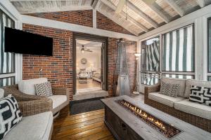 a living room with a couch and a fireplace at Mansion with Pub in Basement in Grosse Pointe Park