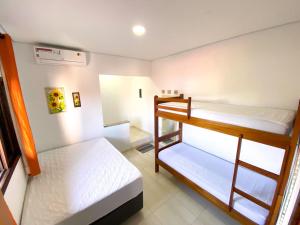 a small room with two bunk beds in it at Barreto Hospedagem in Caraguatatuba +52 photos