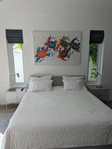 uma cama branca num quarto com 2 janelas em The Oasis Villa Just 150m to the Beach em Koh Samui
