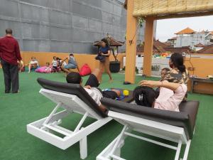 a group of people sitting in chairs on the floor at Genta House in Kuta