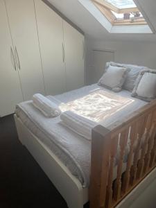 a bedroom with a large bed with a skylight at Home Sweet Home in RG1 with FREE Parking in Reading