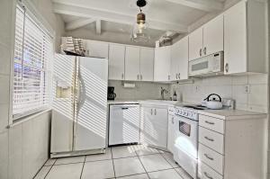 a white kitchen with white appliances and white cabinets at Gulfside Resort Unit 9 in St. Pete Beach