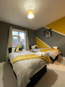 a bedroom with two beds and a window at Home Sweet Home in RG1 with FREE Parking in Reading