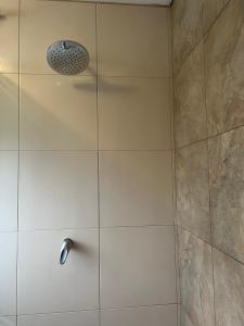 a shower with a shower head in a bathroom at Brand new Holiday Villa - 3 bedroom 4 bathroom in Baños