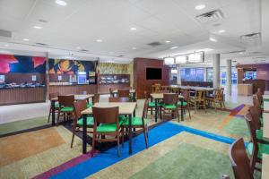 a dining room with tables and chairs in a restaurant at Fairfield Inn & Suites by Marriott Bloomsburg in Bloomsburg