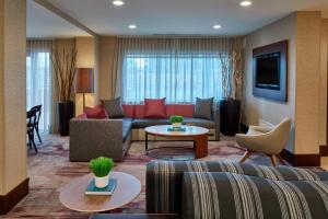 a living room with a couch and a table at Courtyard by Marriott Albany Thruway in Albany