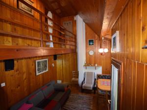 a living room with wooden walls and a couch at Restful Holiday Home in Vrbovsko with Garden and Barbecue in Vrbovsko