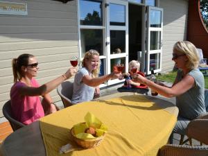 a group of women sitting around a table drinking wine at Bungalow in Netherlands with Ship-Like Design in 's-Gravenzande +32 photos