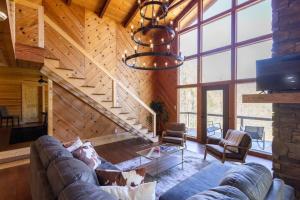 a living room with a couch and a staircase at Family Cabin Near Smoky Mtn Entrance Nantahala in Robbinsville