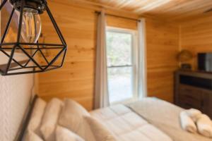 a bedroom with a bed and a window at Family Cabin Near Smoky Mtn Entrance Nantahala in Robbinsville