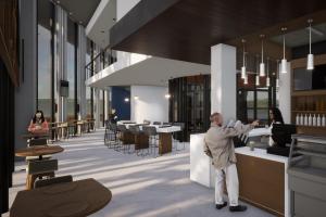 a man standing at a counter in a building at Courtyard by Marriott Tuxpan Veracruz in Tuxpan de Rodríguez Cano