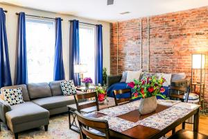 a living room with a brick wall at Cityscape 2 -Sleep 7 in Chattanooga