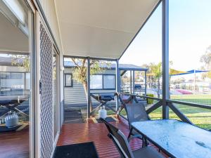 an open patio with a table and chairs on a deck at NRMA Yarrawonga Mulwala Holiday Park in Mulwala