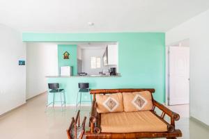 a living room with a couch and a kitchen at SDQ airport & Samana bus near Bamboo in Santo Domingo