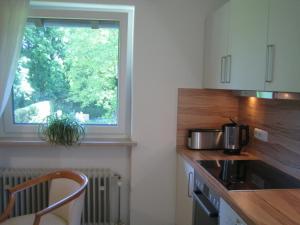a kitchen with a counter top and a window at Ferienwohnung Mautweg in Bad Reichenhall