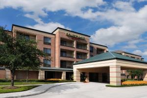 a hotel with a sign on the front of it at Courtyard by Marriott Houston Northwest in Houston