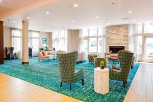 a lobby with chairs and a fireplace at Fairfield Inn & Suites by Marriott Savannah Downtown/Historic District in Savannah