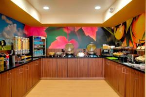 a fast food restaurant with a bar with pink umbrellas on the wall at Fairfield Inn by Marriott Las Cruces in Las Cruces