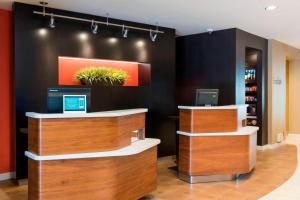 a cashier counter in a store with plants on the wall at Courtyard by Marriott Livermore in Livermore