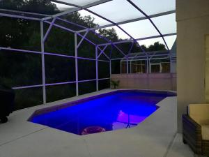 a swimming pool in a house with a glass roof at Private house Kissimmee/Orlando in Kissimmee