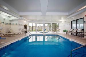 a large swimming pool with blue water in a house at Courtyard Missoula in Missoula