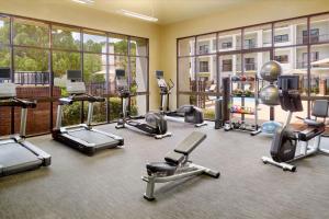 a fitness room with several treadmills and exercise machines at Courtyard by Marriott Atlanta Executive Park/Emory in Atlanta