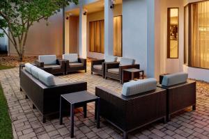 a group of chairs and tables on a patio at Courtyard by Marriott Atlanta Executive Park/Emory in Atlanta