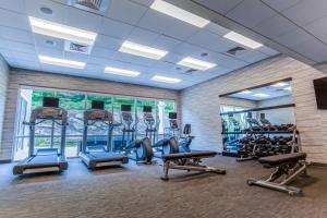 a gym with several treadmills and elliptical machines at Courtyard by Marriott Lenox Berkshires in Lenox