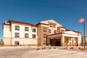 a hotel with an american flag in front of it at Fairfield Inn & Suites by Marriott Alamosa in Alamosa