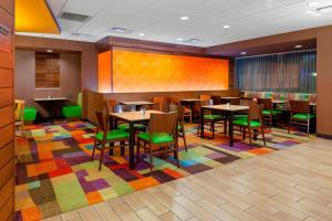 a restaurant with tables and chairs on a colorful rug at Fairfield Inn & Suites by Marriott Alamosa in Alamosa