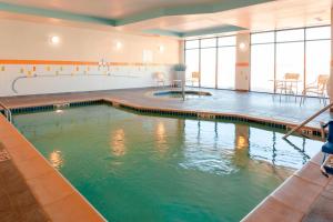 a swimming pool with green water in a building at Fairfield Inn & Suites by Marriott Alamosa in Alamosa