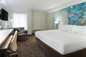 a hotel room with a large white bed and a couch at Courtyard Miami Downtown Brickell Area in Miami