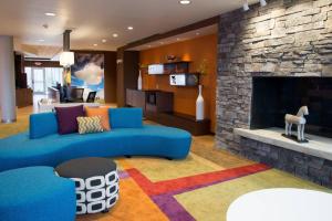 a living room with a blue couch and a fireplace at Fairfield Inn & Suites by Marriott Dickson in Dickson