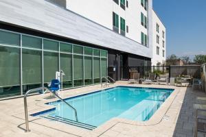 a swimming pool in front of a building at SpringHill Suites by Marriott Riverside Redlands in Redlands