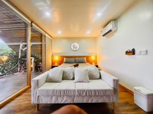 a bedroom with a white bed and a large window at Tantawan sea view residence 山海居 in Salad Beach