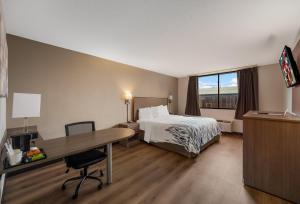 a hotel room with a bed and a desk at Red Roof Inn Painted Post in Painted Post +37 photos