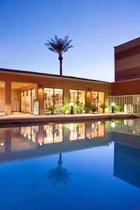 a house with a swimming pool at night at Courtyard by Marriott Scottsdale Old Town in Scottsdale