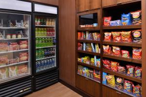 a grocery store aisle with drinks and snacks at Fairfield Inn and Suites by Marriott Calhoun in Calhoun