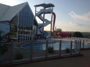 a playground with a water slide in front of a building at Ritz Summerhouse in Hastings
