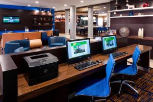 an office with two computer monitors on a desk at Courtyard by Marriott Houston North/Shenandoah in The Woodlands