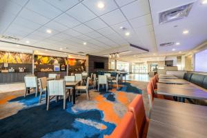 a restaurant with tables and chairs on a carpet with a map at Fairfield Inn & Suites by Marriott St. Joseph Stevensville in Stevensville