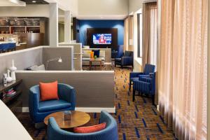 a waiting room with blue chairs and a table at Courtyard by Marriott Phoenix North in Phoenix