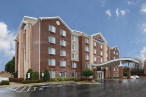 a large red brick building with a parking lot at Fairfield Inn Greensboro Airport in Greensboro