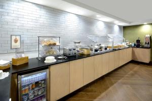 a restaurant kitchen with a counter with food at Fairfield Inn Greensboro Airport in Greensboro