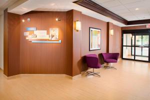 a waiting room with two purple chairs and a wall at Fairfield Inn & Suites by Marriott Lafayette South in Lafayette