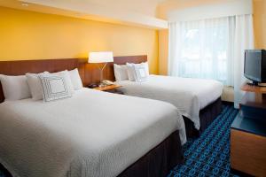 a hotel room with two beds and a television at Fairfield Inn & Suites by Marriott Lafayette South in Lafayette